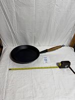 Full view of Le Creuset skillet with tape measure showing length