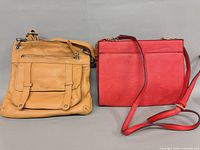 Front view of both crossbody bags, tan and red