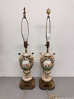 Full view of both matching porcelain lamps with harps and finials