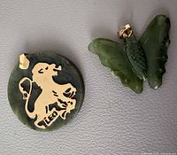Front view of jade Leo disc pendant and jade butterfly pendant