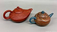 Both teapots side by side showing shapes, colors and overall condition