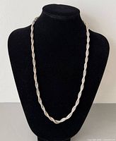 Necklace displayed on bust form showing full length and twist design