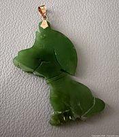 Front view of jade dog pendant with gold bail