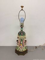 Full view of lamp with harp, bulb, cord visible