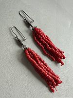 Front view of both coral tassel earrings
