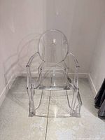 Front view of clear acrylic armchair showing full design