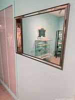 Front view of large silver-framed horizontal mirror mounted on wall