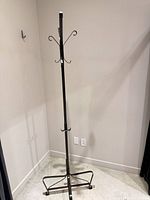 Full view of metal coat rack against wall
