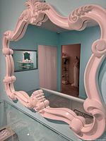 Full view of ornate white mirror on wall