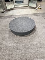Top view of gray carpeted circular pedestal