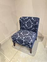 Front three-quarter view of chair showing upholstery and legs