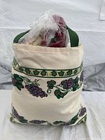 Canvas tote standing upright with contents visible at top
