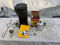 Group shot showing all items: Farberware coffee maker, Kloc moka pot with box, three metal candle hooks, two glass dishes, floral handle teaspoons