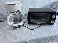 Mr. Coffee coffee maker next to Home Exclusives toaster oven, exterior view
