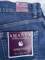 Close-up of brand tag on jeans pocket showing Amanda Supreme Stretch Gloria Vanderbilt