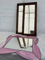 Front view showing stained glass mirror and wood framed mirror