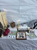 Group shot of all items including bulbs, tiles, bowling balls, wall canvas, basket, rug holder, mosaic tile and sign