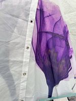 White shower curtain with purple iris print and grommet edge