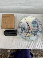 All three clock items: boxed Magnasonic, Capello alarm, Thomas Kinkade wall clock