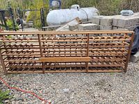 Front view of cedar wood wine rack showing full length and tiered bottle slots
