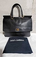 Front view of black Dolce & Gabbana Miss Sicily handbag with dust bag