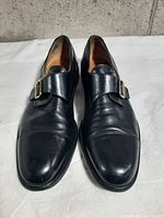 Shoes front view showing cap toes, leather condition, buckle detail