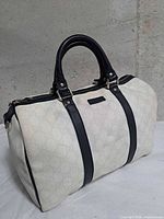 Front view of Gucci canvas Boston bag with black leather trim