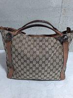 Front view of Gucci GG canvas hobo showing pattern, handles, hardware