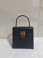 Front view showing shape, leather, Gancini clasp, handle