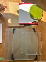 All seven items laid out: three cutting boards above four glass panels