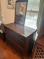 Front view of oak dresser showing drawers, mirror, finish, carving