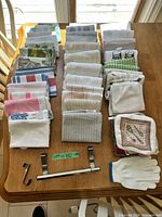 All folded towels in four columns plus bar, hook and gloves