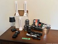 Group shot of all lighting items, batteries and tester on table