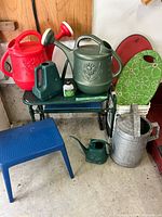 Group shot of all items including watering cans, kneeler, kneeling pads, step stool, fertilizer