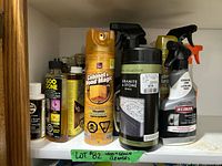 Front view of assorted cleaners on shelf showing Goo Gone, Cabinet & Wood Magic, Stone Collection wipes, Weiman cleaner and more