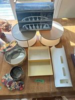All items grouped: chrome dispenser, two turntables, large tin, nested tins, tray organizer