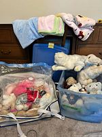 overall lot showing plush in tote, blankets on chair