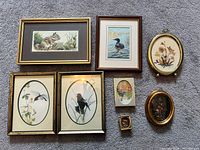 All seven framed artworks laid out for overview