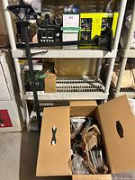 Overview of shelves with boxed solar lights and open box of loose stakes