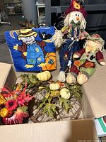Complete lot showing flag, both dolls, wreath and floral arrangement