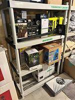 Full view of assembled plastic shelving unit showing four shelves and color