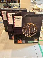 Front view of three sealed Canvas Twinkling Orb boxes