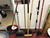 Lineup of bucket, brooms, pole and brushes