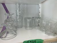 Lot overview showing dessert bowls, dimply tumblers, fluted tumblers, square ribbed tumblers