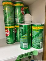 Shelf view of multiple Comet powder canisters and gel bottle