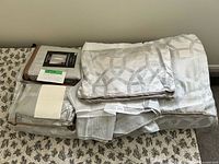 Stacked packaged comforter set pieces and folded panels