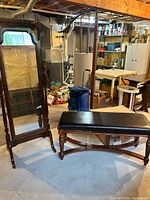 Cheval mirror and matching bench shown together in basement setting