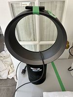 Front view of Dyson AM06 bladeless fan with power cord