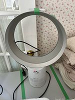 Front view of Dyson AM06 fan showing loop, base and cord