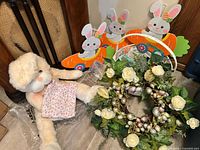 Lot overview showing plush bunny, bunny signs, basket, wreath